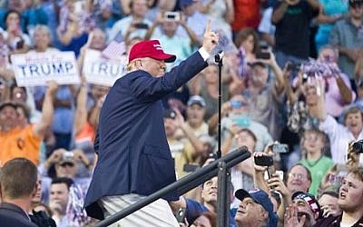 Republican presidential candidate Donald Trump waves to supporters during a campaign rally in Mobile, Alabama on Friday, August 21, 2015 (AP Photo/Brynn Anderson)