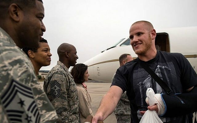 In this Aug. 24, 2015 picture, provided by US Airforce Ramstein, Airman 1st Class Spencer Stone, right, meets Chief Master Sgt. Phillip Easton, 86th Airlift Wing command chief, upon his arrival to Ramstein Air Base, Germany. (Staff Sgt. Sara Keller/US Air Force via AP)