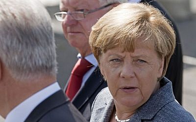 German Chancellor Angela Merkel arrives at a refugee shelter that was attacked by far-right protesters in Heidenau, eastern Germany, Wednesday, Aug. 26, 2015. (AP Photo/Jens Meyer)