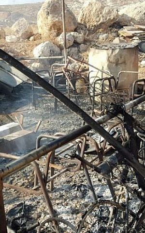 The charred remains of a Bedouin tent after an arson attack in the West Bank, August 13, 2015. (Zakaria Sadeh/Rabbis for Human Rights)