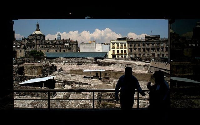 In this Friday, Aug. 7, 2015, file photo, a worker, standing in front of ongoing excavations at the Templo Mayor archaeological site, directs people into the adjoining museum, in central Mexico City. (AP Photo/Rebecca Blackwell, File) In this Friday, Aug. 7, 2015, file photo, a worker, standing in front of ongoing excavations at the Templo Mayor archaeological site, directs people into the adjoining museum, in central Mexico City. (AP Photo/Rebecca Blackwell, File)
