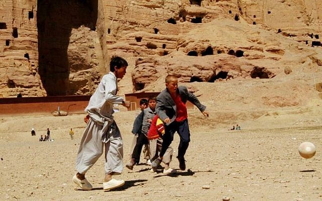 In this Monday, April 9, 2007, file photo, Afghan boys play soccer in front of the area where the enormous Buddha statues once stood in Bamiyan province, before their destruction at the hands of the Taliban in March 2000. (AP Photo/Amir Shah, File) In this Monday, April 9, 2007, file photo, Afghan boys play soccer in front of the area where the enormous Buddha statues once stood in Bamiyan province, before their destruction at the hands of the Taliban in March 2000. (AP Photo/Amir Shah, File)