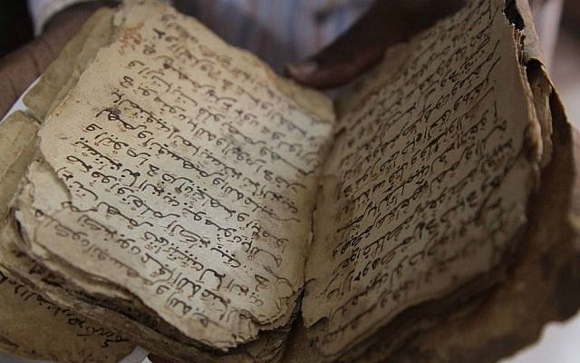 In this Tuesday, Jan. 27, 2015, file photo, a man holds an ancient manuscript that will need to be restored after being damaged by Islamic extremists in Bamako, Mali. (AP Photo/Baba Ahmed, File) In this Tuesday, Jan. 27, 2015, file photo, a man holds an ancient manuscript that will need to be restored after being damaged by Islamic extremists in Bamako, Mali. (AP Photo/Baba Ahmed, File)