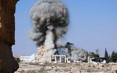 Smoke rises from the detonation of the 2,000-year-old temple of Baal Shamin in Syria's ancient city of Palmyra, August 25, 2015. (Islamic State social media account via AP, File)