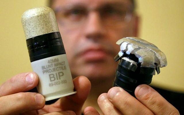 In this Thursday, July 30, 2015 photo, Salvatore Emma Jr., president and CEO of Micron Products, displays Blunt Impact Projectiles, one ready for use, left, and another after being fired during a test at the factory in Fitchburg, Massachusetts. (AP Photo/Steven Senne) In this Thursday, July 30, 2015 photo, Salvatore Emma Jr., president and CEO of Micron Products, displays Blunt Impact Projectiles, one ready for use, left, and another after being fired during a test at the factory in Fitchburg, Massachusetts. (AP Photo/Steven Senne)