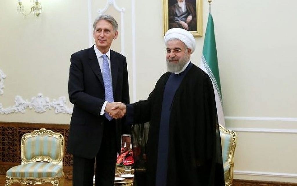 Iran's President Hassan Rouhani, right, welcomes then-British Foreign Secretary Philip Hammond at the start of their meeting in his office, in Tehran, Iran, Monday, Aug. 24, 2015. (AP Photo/Ebrahim Noroozi)