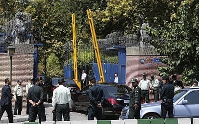 Escorted by Iranian police, a convoy carrying British Foreign Secretary Philip Hammond enters the British Embassy in Tehran, Iran, Sunday, Aug. 23, 2015. (AP Photo/Ebrahim Noroozi)
