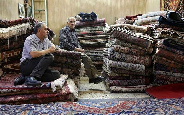 In this Monday, Aug. 10, 2015 photo, Iranian merchants wait for customers at a carpet shop in Tehran's old main bazaar, Iran. (AP Photo/Vahid Salemi) In this Monday, Aug. 10, 2015 photo, Iranian merchants wait for customers at a carpet shop in Tehran's old main bazaar, Iran. (AP Photo/Vahid Salemi)