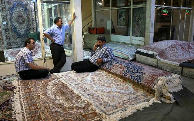 In this Monday, Aug. 10, 2015 photo, Iranian merchants wait for customers at a carpet market in Tehran's old main bazaar, Iran. (AP Photo/Vahid Salemi) In this Monday, Aug. 10, 2015 photo, Iranian merchants wait for customers at a carpet market in Tehran's old main bazaar, Iran. (AP Photo/Vahid Salemi)