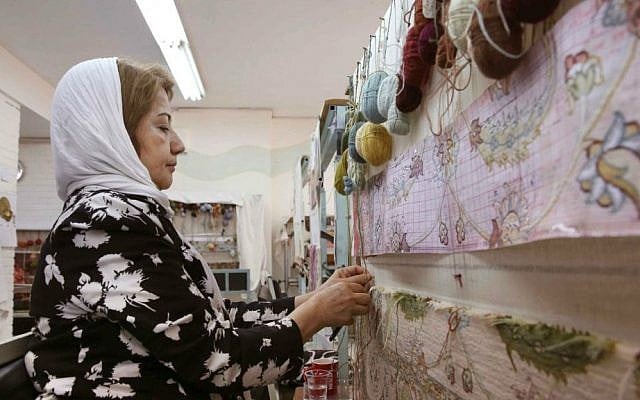 In this Tuesday, Aug. 4, 2015 photo, an Iranian woman weaves a carpet at a workshop by the Cultural and Artistic Carpet Foundation of Rassam Arabzadeh in Tehran, Iran. (AP Photo/Vahid Salemi) In this Tuesday, Aug. 4, 2015 photo, an Iranian woman weaves a carpet at a workshop by the Cultural and Artistic Carpet Foundation of Rassam Arabzadeh in Tehran, Iran. (AP Photo/Vahid Salemi)