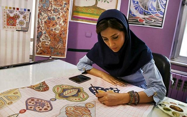 In this Tuesday, Aug. 4, 2015 photo, an Iranian woman sketches and paints carpet patterns at a workshop in the Cultural and Artistic Carpet Foundation of Rassam Arabzadeh in Tehran, Iran. (AP Photo/Vahid Salemi) In this Tuesday, Aug. 4, 2015 photo, an Iranian woman sketches and paints carpet patterns at a workshop in the Cultural and Artistic Carpet Foundation of Rassam Arabzadeh in Tehran, Iran. (AP Photo/Vahid Salemi)
