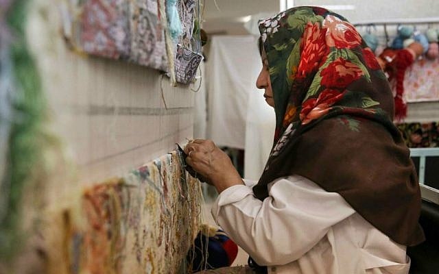 In this Tuesday, Aug. 4, 2015 photo, an Iranian woman weaves a carpet at a workshop of the Cultural and Artistic Carpet Foundation of Rassam Arabzadeh in Tehran, Iran. (AP Photo/Vahid Salemi) In this Tuesday, Aug. 4, 2015 photo, an Iranian woman weaves a carpet at a workshop of the Cultural and Artistic Carpet Foundation of Rassam Arabzadeh in Tehran, Iran. (AP Photo/Vahid Salemi)