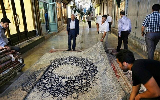 In this Monday, Aug. 10, 2015 photo, Iranian merchants display a carpet at the Tehran's old main bazaar, Iran. (AP Photo/Vahid Salemi) In this Monday, Aug. 10, 2015 photo, Iranian merchants display a carpet at the Tehran's old main bazaar, Iran. (AP Photo/Vahid Salemi)