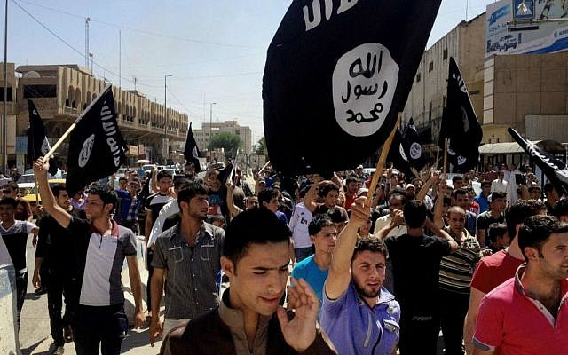 Illustrative photo of demonstrators chanting pro-Islamic State slogans as they carry the group's flags in front of the provincial government headquarters in Mosul, Iraq, June 16, 2014. (AP, File) Illustrative photo of demonstrators chanting pro-Islamic State slogans as they carry the group's flags in front of the provincial government headquarters in Mosul, Iraq, June 16, 2014. (AP, File)