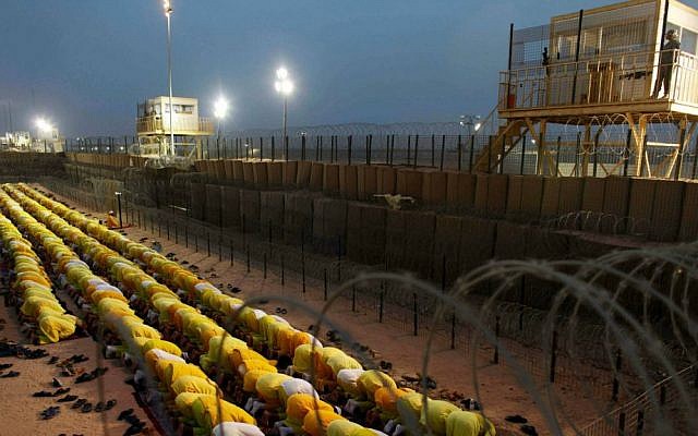 In this March 16, 2009 file photo, detainees pray at the former US military detention facility Camp Bucca, Iraq. (AP Photo/Dusan Vranic, File)