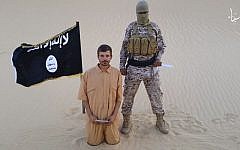 This image made from a militant video posted on a social media site on Wednesday, August 5, 2015, which has been verified and is consistent with other AP reporting, purports to show a militant standing next to another man who identifies himself as 30-year-old Tomislav Salopek, kneeling down as he reads a message at an unknown location. (Screen capture via AP)