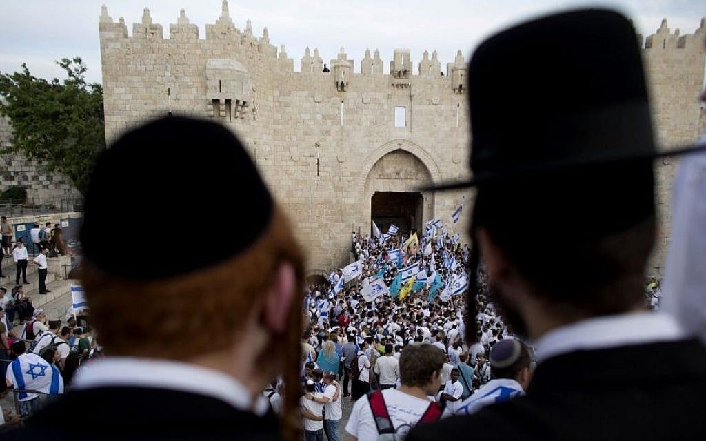 In this May 28, 2014, file photo, ultra-Orthodox Jews watch people wave Israeli flags outside the Old City's Damascus Gate during Jerusalem Day celebrations in Jerusalem. (AP Photo/Dusan Vranic, File) In this May 28, 2014, file photo, ultra-Orthodox Jews watch people wave Israeli flags outside the Old City's Damascus Gate during Jerusalem Day celebrations in Jerusalem. (AP Photo/Dusan Vranic, File)