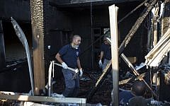 Israeli policemen inspect a house after it was torched in a suspected attack by Jewish terrorists killing an 18-month-old Palestinian child, at Duma village near the West Bank city of Nablus, Friday, July 31, 2015. (AP Photo/Majdi Mohammed)