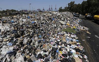 Piles of garbage blocks a street in east Beirut, Lebanon, Monday, Aug. 17, 2015. (AP Photo/Hassan Ammar) 