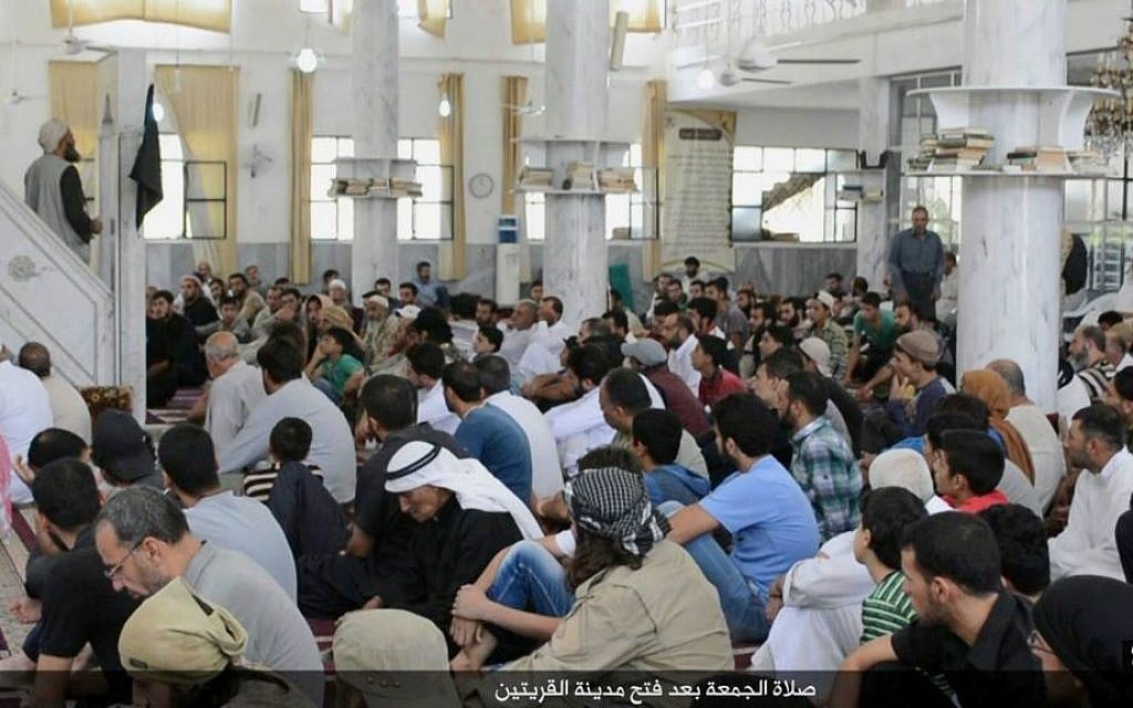 In this photo provided Friday, Aug. 7, 2015, by the Rased News Network, a Facebook page affiliated with Islamic State militants, Muslim worshipers attend Friday prayers in a mosque in the central Syrian town of Qaryatain. (Rased News Network, a Facebook page affiliated with Islamic State militants via AP)
