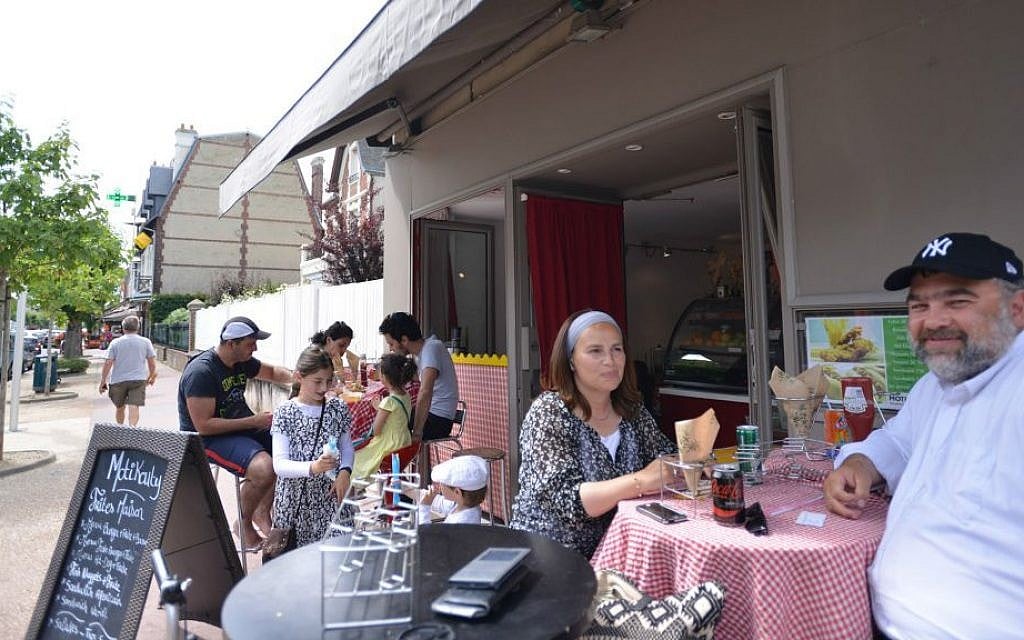 Nadia and Shimon Wilhelm at a kosher restaurant in the French resort town of Deauville, July 24, 2015. (Cnaan Liphshiz/JTA)