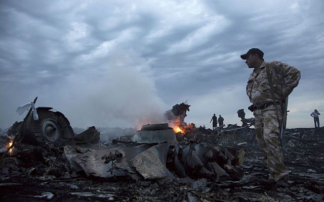 In this July 17, 2014 file photo, people walk amongst the debris at the crash site of a passenger plane near the village of Grabovo, Ukraine. (AP Photo/Dmitry Lovetsky) In this July 17, 2014 file photo, people walk amongst the debris at the crash site of a passenger plane near the village of Grabovo, Ukraine. (AP Photo/Dmitry Lovetsky)