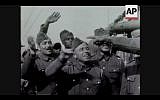 Members of a Palestinian unit in 1940 wave to the camera on their way to join the Allies in France (Screenshot of newsreel footage from YouTube)