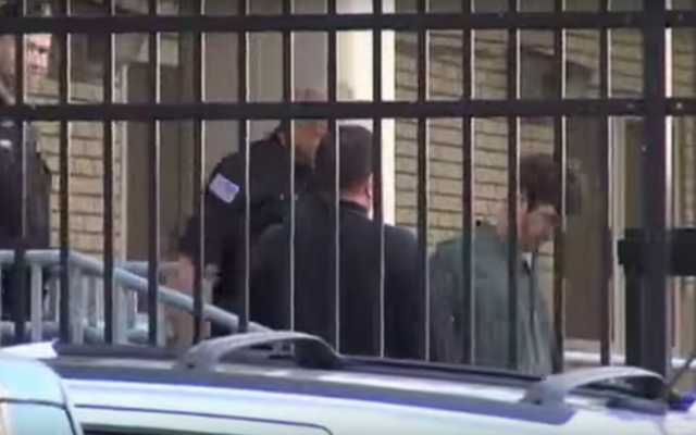 Glendon Scott Crawford accompanied by police after his arrest in 2013 (screen capture: YouTube) Glendon Scott Crawford accompanied by police after his arrest in 2013 (screen capture: YouTube)