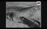 Men shovel out snow after a rare Jerusalem snowstorm in February 1957 (Screenshot of newsreel footage from YouTube)