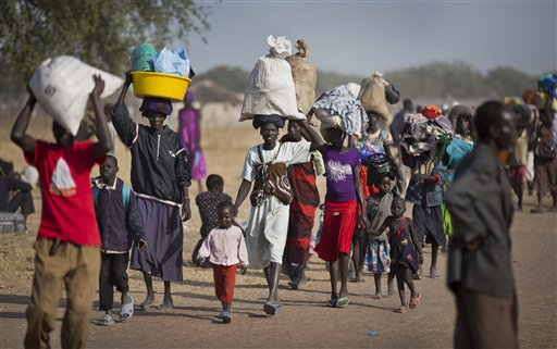 FILE - In this Thursday, Jan. 2, 2014 file photo, displaced people walk to find an unoccupied patch of ground where they can rest after arriving by river barge from Bor, some of the thousands who fled fighting between government and rebel forces in Bor by boat across the White Nile, in the town of Awerial, South Sudan. (Ben Curtis/AP) FILE - In this Thursday, Jan. 2, 2014 file photo, displaced people walk to find an unoccupied patch of ground where they can rest after arriving by river barge from Bor, some of the thousands who fled fighting between government and rebel forces in Bor by boat across the White Nile, in the town of Awerial, South Sudan. (Ben Curtis/AP)