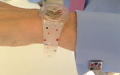Israel Museum director James Snyder models the commemorative 50th anniversary Swatch watch, whose design is based on his own personal cuff links. (courtesy of James Snyder)
