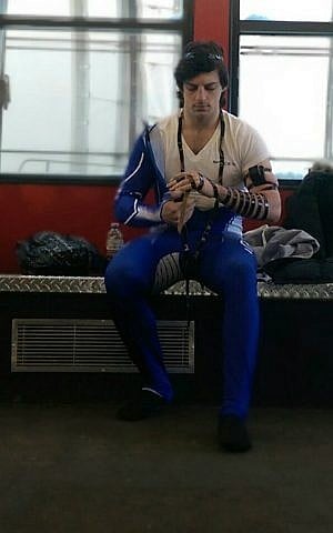 Self-described 'ambassador for all things Jewish' AJ Edelman prays with tefillin before a competition. (courtesy) Self-described 'ambassador for all things Jewish' AJ Edelman prays with tefillin before a competition. (courtesy)