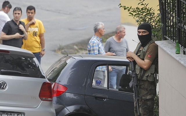 A masked Turkish police officer secures a road leading to the US Consulate building in Istanbul, August 10, 2015. (AP/Lefteris Pitarakis) A masked Turkish police officer secures a road leading to the US Consulate building in Istanbul, August 10, 2015. (AP/Lefteris Pitarakis)