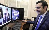 Iraqi Ahmad al-Basheer, host of the "Basheer Show", watches a video of his TV show on a computer screen on July 29, 2015 at his studio in the Jordanian capital, Amman. (AFP PHOTO / KHALIL MAZRAAWI)