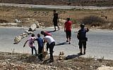 Palestinians use rocks to close off a street during a protest in the Palestinian village of Nabi Saleh, August 28, 2015. (Eric Cortellessa/Times of Israel)