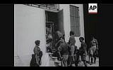 British soldiers search a house in Tel Aviv for terrorists during a four-day curfew in 1946 (Screenshot of newsreel footage from YouTube)