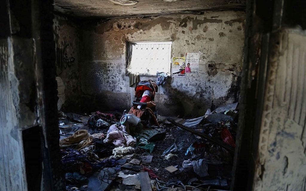 Inside the Dawabsha home in Duma. A doll wrapped in a Palestinian flag rests in a stroller to honor Ali. (Eric Cortellessa/Times of Israel)