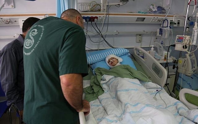 A doctor talks with Ahmed Dawabsha at Sheba Medical Center in Tel HaShomer Eric Cortellessa/Times of Israel)