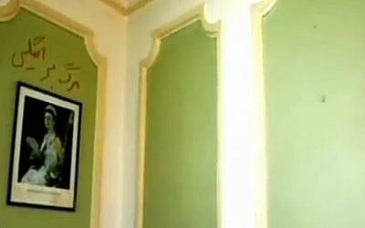 Four-year-old graffiti reading 'Death to England' is seen above a portrait of Queen Elizabeth II at the British embassy in Tehran as it reopened on August 23, 2015, for the first time since November 2011 riots. (screen capture: Channel 2) 