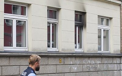 A Police officer stands in front of a house planned to be a refugee shelters in Leipzig on August 26, 2015. A suspect was caught flinging a Molotov cocktail into the refugee homewhich was due to house 56 asylum-seekers, police said. (AFP Photo/DPA/Sebastian Willnow) A Police officer stands in front of a house planned to be a refugee shelters in Leipzig on August 26, 2015. A suspect was caught flinging a Molotov cocktail into the refugee homewhich was due to house 56 asylum-seekers, police said. (AFP Photo/DPA/Sebastian Willnow)