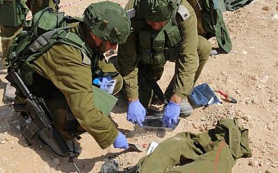 Members of the Eitan Unit, who search for missing bodies, collect blood samples as part of a training exercise. (Eric Cortellessa/Times of Israel)