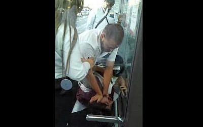 A Jerusalem light rail guard attacks an American tourist in this video that aired August 3, 2015 on Channel 10. (Screenshot)
