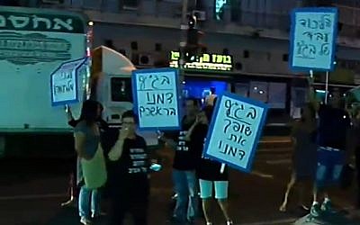 Residents of south Tel Aviv rally on August 11, 2015 against a High Court ruling that limits detention time for migrants, but upholds the government 'infiltration law' (screen capture: Channel 2)
