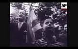 In 1948, people gathered outside the Jewish Agency building in Washington, D.C., to celebrate the birth of the Jewish State (Screenshot of newsreel footage from YouTube)
