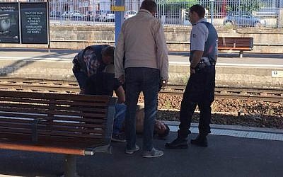 A photo taken by a passenger with a smartphone through the window of a Thalys train shows police detaining a suspect on the platform at the main train station in Arras, northern France, on August 21, 2015 (AFP/CHRISTINA CATHERINE COONS)