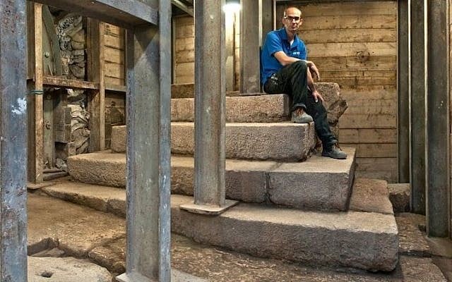 Joe Uziel, co-director of an Israel Antiques Authority excavation, sitting atop the stepped structure from the Second Temple period in Jerusalem. (Shai Halevy/ Israel Antiquities Authority) Joe Uziel, co-director of an Israel Antiques Authority excavation, sitting atop the stepped structure from the Second Temple period in Jerusalem. (Shai Halevy/ Israel Antiquities Authority)