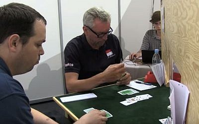 Israeli Bridge player Ron Schwartz, left, at an international tournament in 2014. (screen capture: YouTube)