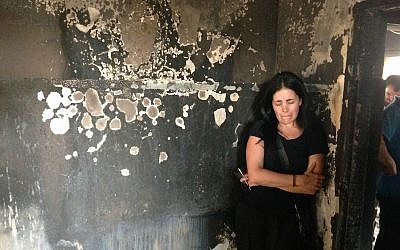 Tali Mizrahi, a member of the anti-racism group Light Tag, Tag Meir, visiting the home of a Palestinian baby allegedly killed by Jewish arsonists. (Ben Sales/JTA)