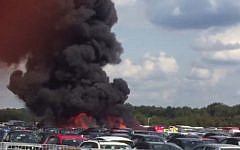 Smoke rises from the site of a plane crash in the UK on July 31, 2015, in which members of the bin Laden family were killed. (screen capture: BBC)