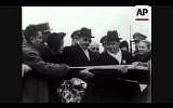 In this screenshot, Chaim Weizmann cuts a tape to symbolize his official entrance into Jerusalem for his inauguration as president (Photo courtesy AP)